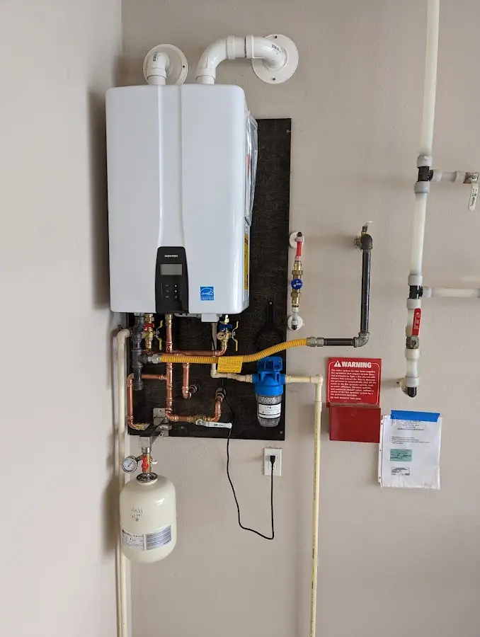 Professional plumber installing copper piping in a Spartanburg home